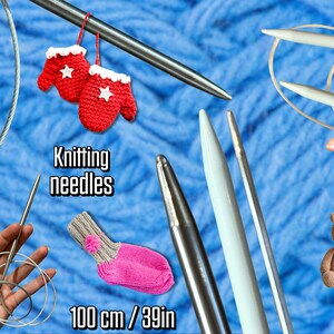 Puede incluir: Agujas de tejer y accesorios sobre un fondo azul tejido. La imagen incluye varias agujas de tejer, mitones rojos, un calcetín rosa y gris y un pequeño oso de peluche. El texto dice "Knitting needles" y "100 cm / 39in".
