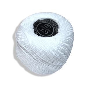 May include: A ball of white pearl cotton thread with a black and white label in the center. The label reads "GT GOLD THREAD" and "MADE IN CHINA". The thread is tightly wound, showing the texture of the cotton.