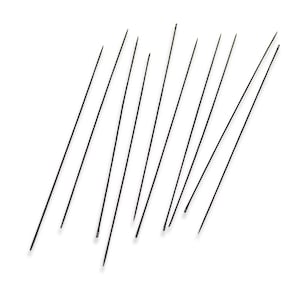 May include: A collection of thin, black needles arranged diagonally against a white background. The needles are evenly spaced and appear to be made of metal. The image is a close-up shot, highlighting the sharp points of the needles.