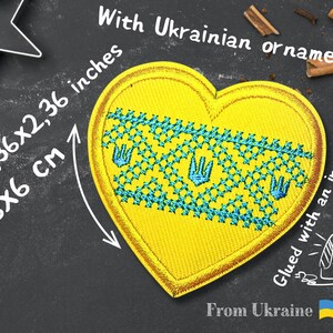 May include: Yellow heart-shaped patch with a blue and yellow Ukrainian ornament. The patch is 2.36x2.36 inches or 6x6 cm. The text "Glued with an iron" and "From Ukraine" is written on the image.