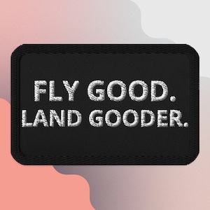 May include: Black embroidered patch with white stitching that reads "FLY GOOD. LAND GOODER."