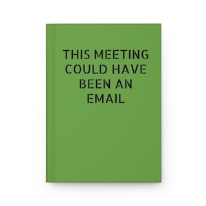 May include: A green notebook with the text "THIS MEETING COULD HAVE BEEN AN EMAIL" printed in black.
