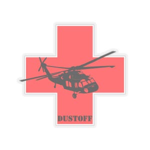May include: A sticker featuring a gray helicopter silhouette over a red cross shape. The word "DUSTOFF" is printed in gray block letters at the bottom of the cross. The sticker has a white border.