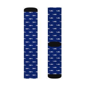 May include: A pair of blue socks with a white helicopter pattern.