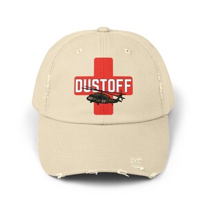 May include: A beige distressed baseball cap with a red medical cross and the text "DUSTOFF" in white. A green helicopter is flying over the cross.