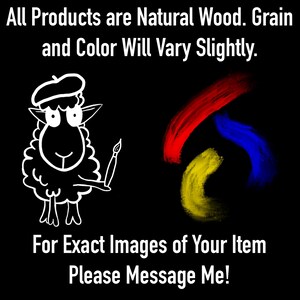 May include: A black graphic featuring white text that reads All Products are Natural Wood. Grain and Color Will Vary Slightly. A white line drawing of a sheep wearing a beret and holding a paintbrush, with red, yellow, and blue paint strokes. For Exact Images of Your Item Please Message Me!