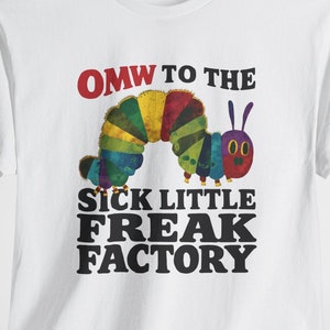 May include: White t-shirt with a colorful caterpillar graphic and the text "OMW to the Sick Little Freak Factory".
