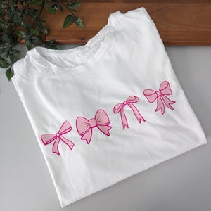 Pretty pink bows girly women&#39;s tshirt. Cute pink bows. Graphic tee women&#39;s shirt. Bows