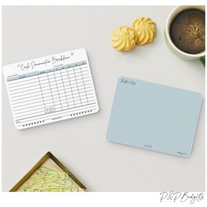 May include: A white printable cash denomination breakdown sheet with a black border and a handwritten title "Cash Denomination Breakdown". The sheet is divided into columns for date, denomination, amount, and total amount. There is a light blue blank sheet with the text "Thoughts & Prayers" in the top left corner.