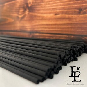 May include: A bundle of black diffuser reeds, arranged in a fan shape, with the text "Lottie Elizabeth LTD" at the bottom of the image.