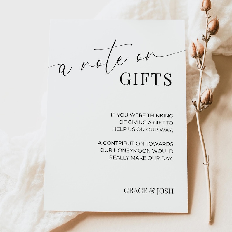 May include: A white card with black text that reads "a note on GIFTS" and includes the message "If you were thinking of giving a gift to help us on our way, a contribution towards our honeymoon would really make our day." The card is signed "GRACE & JOSH".