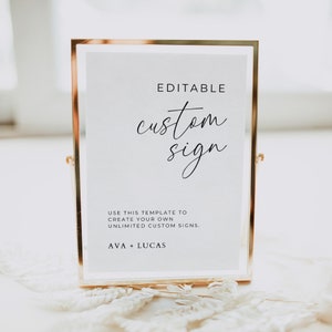 May include: A gold-framed sign with a white background and black text. The sign says "EDITABLE custom sign" and "USE THIS TEMPLATE TO CREATE YOUR OWN UNLIMITED CUSTOM SIGNS. AVA + LUCAS".