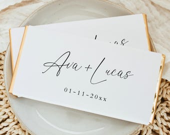 May include: White chocolate bar with gold foil wrapping. The bar is personalized with the text "Ava + Lucas" and the date "01-11-20XX".