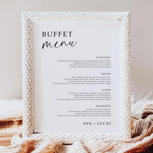 May include: A white framed buffet menu with the word "BUFFET" at the top and "menu" in cursive below. The menu lists starters, mains, sides, and desserts with various food items. The bottom of the menu reads "AVA + LUCAS".