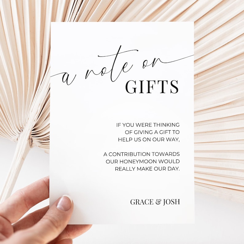 May include: A white card with black text that reads "a note on GIFTS". The text continues, "If you were thinking of giving a gift to help us on our way, a contribution towards our honeymoon would really make our day." The card is signed "GRACE & JOSH".