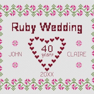 May include: A cross-stitch pattern for a ruby wedding anniversary card. The design features a heart made of small red hearts with the number 40 in the center and the words "years" below. The names John and Claire are on either side of the heart. The text "Ruby Wedding" is at the top of the design. The year 20XX is at the bottom of the design.