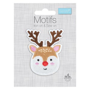 May include: An iron-on and sew-on embroidered patch featuring a reindeer head with brown antlers, a tan and white face, pink inner ears and cheeks, and a bright red nose. The patch is displayed on a grey card labelled Motifs Trimits.