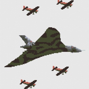 May include: A green and black camouflage bomber plane flying over four smaller red and black planes.