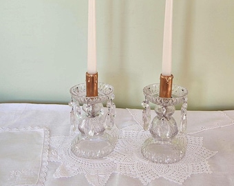 Pair of cut glass candlesticks with prismatic drops.