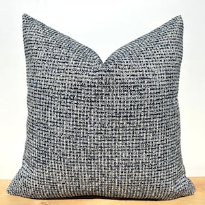 This cushion cover will impress with its textured soft boucle fabric and navy blue and white colours. Our throw pillows are double-sided and have a hidden zipper, and are available in all sizes, including large and lumbar.