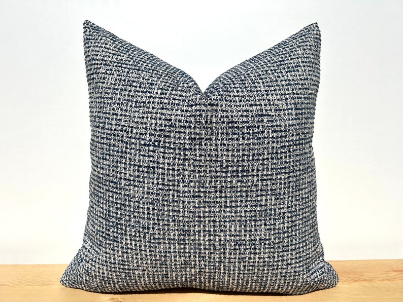 This cushion cover will impress with its textured soft boucle fabric and navy blue and white colours. Our throw pillows are double-sided and have a hidden zipper, and are available in all sizes, including large and lumbar.