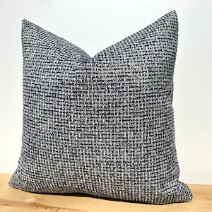 This cushion cover will impress with its textured soft boucle fabric and navy blue and white colours. Our throw pillows are double-sided and have a hidden zipper, and are available in all sizes, including large and lumbar.