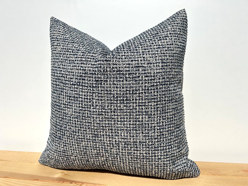 This cushion cover will impress with its textured soft boucle fabric and navy blue and white colours. Our throw pillows are double-sided and have a hidden zipper, and are available in all sizes, including large and lumbar.