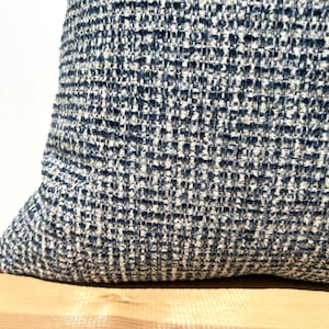 This cushion cover will impress with its textured soft boucle fabric and navy blue and white colours. Our throw pillows are double-sided and have a hidden zipper, and are available in all sizes, including large and lumbar.