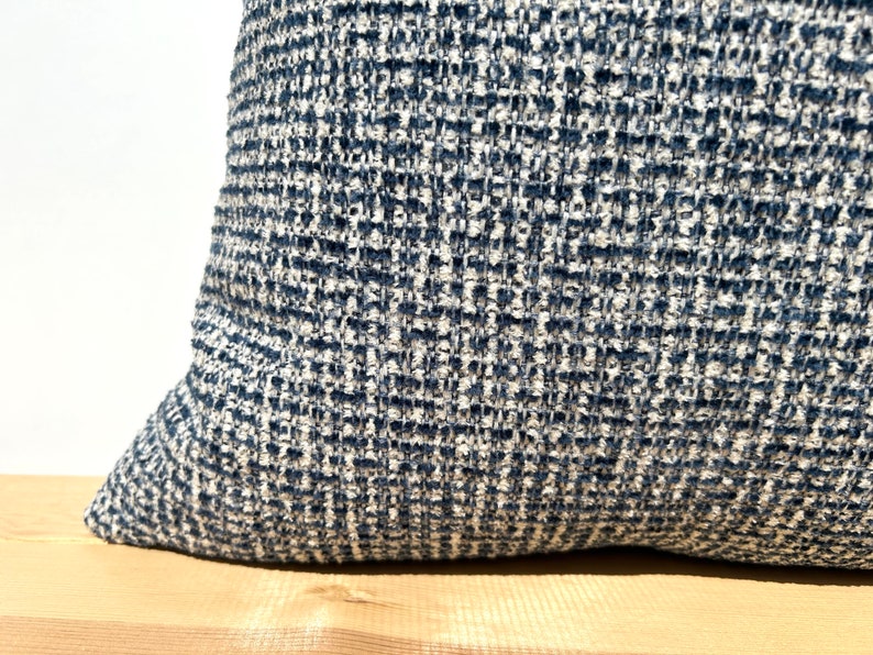 This cushion cover will impress with its textured soft boucle fabric and navy blue and white colours. Our throw pillows are double-sided and have a hidden zipper, and are available in all sizes, including large and lumbar.