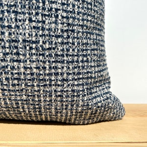 This cushion cover will impress with its textured soft boucle fabric and navy blue and white colours. Our throw pillows are double-sided and have a hidden zipper, and are available in all sizes, including large and lumbar.