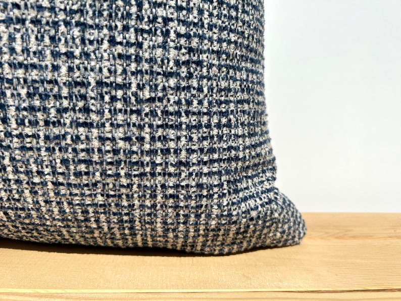 This cushion cover will impress with its textured soft boucle fabric and navy blue and white colours. Our throw pillows are double-sided and have a hidden zipper, and are available in all sizes, including large and lumbar.