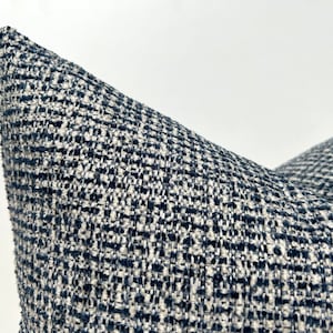 This cushion cover will impress with its textured soft boucle fabric and navy blue and white colours. Our throw pillows are double-sided and have a hidden zipper, and are available in all sizes, including large and lumbar.