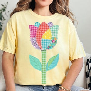 May include: A white ceramic mug with a black handle and the text "But First, Coffee" in a bold, black font. The mug is set against a blurred background, suggesting a cosy setting.