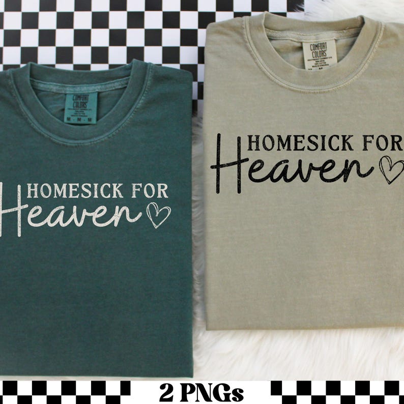 May include: Two Comfort Colors t-shirts, one teal and one khaki, are displayed. Each shirt has the phrase "Homesick for Heaven" printed on the front, with a heart symbol. The shirts are folded and presented on a checkered background.