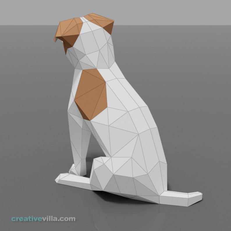 Pu&ograve; includere: Un cane di carta origami bianco e marrone seduto su una superficie grigia. Il cane &egrave; fatto di triangoli e ha un design semplice.
