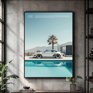 May include: A framed wall art print featuring a white Porsche 930 sports car parked beside a turquoise swimming pool. The scene includes a palm tree, desert landscape, and modern architecture. The text 930 is printed in the upper left corner.