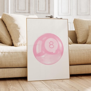 May include: A framed print of a pink 8-ball on a white background. The 8-ball is a classic pool ball with a black number 8 in the center.