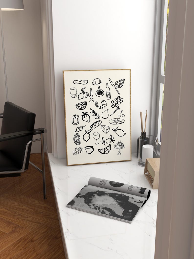 May include: A black and white illustration of various food and drink items, including bread, fruit, wine, and cheese. The illustration is framed and hanging on a white wall.
