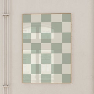 Puede incluir: Una impresi&oacute;n enmarcada con un patr&oacute;n a cuadros en tonos de verde y blanco. La impresi&oacute;n est&aacute; enmarcada en un marco fino de oro.