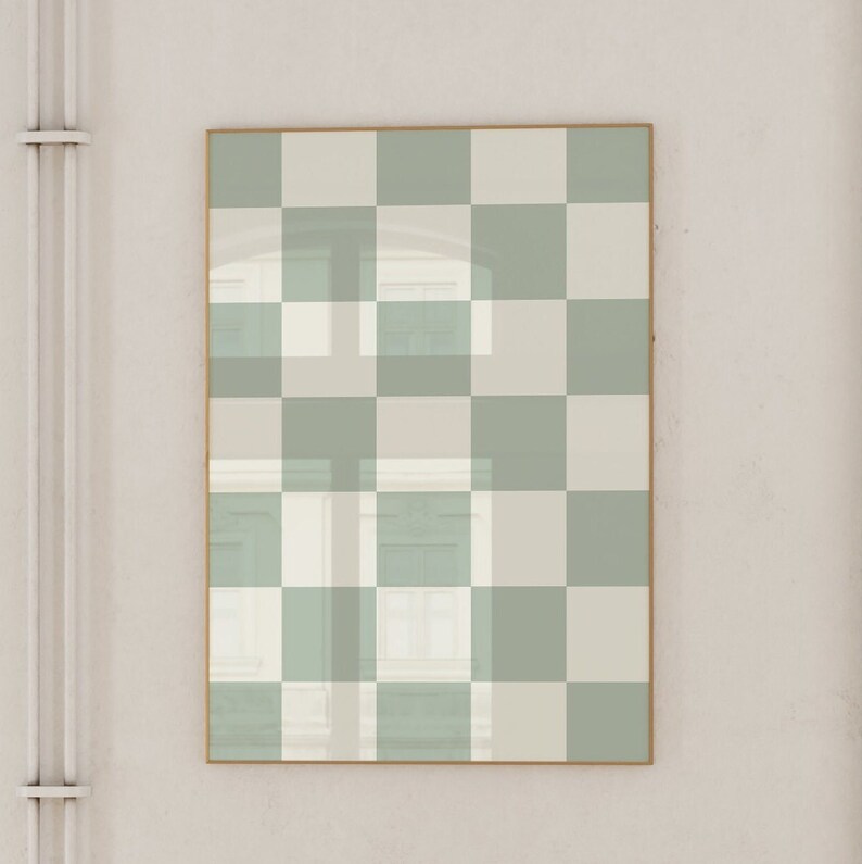 Puede incluir: Una impresi&oacute;n enmarcada con un patr&oacute;n a cuadros en tonos de verde y blanco. La impresi&oacute;n est&aacute; enmarcada en un marco fino de oro.