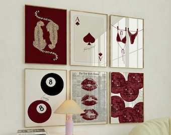 May include: Six framed art prints with various designs. The prints include a pair of cheetahs, a playing card, a bikini, a pool ball, a newspaper with lip prints, and disco balls. The color scheme is primarily burgundy and white.