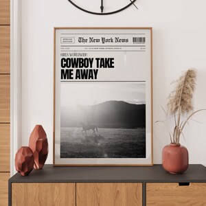 May include: A black and white newspaper clipping with the headline "GIRLS WORLDWIDE: COWBOY TAKE ME AWAY". The image shows a person riding a horse in a field.