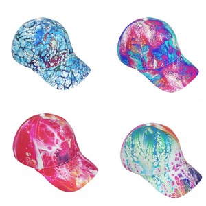Peut inclure: Quatre casquettes de baseball avec des motifs abstraits différents. Les casquettes sont toutes blanches avec des tourbillons et des motifs colorés. Les motifs comprennent le bleu, le rose, le rouge et le vert.