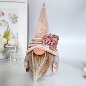 Spring beige a handsome gnomes with floral deco, an original Easter gift for home. Holiday gnome is a Scandinavian home amulet.