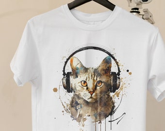 May include: White t-shirt with a watercolor illustration of a cat wearing headphones. The cat is brown and white with green eyes. The background is a light blue with splashes of paint.