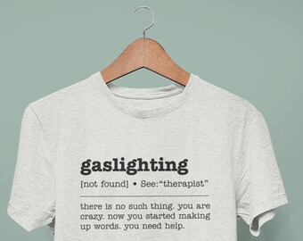 May include: A gray t-shirt with the word "gaslighting" defined as "[not found] See: "therapist"" and the text "there is no such thing. you are crazy. now you started making up words. you need help."