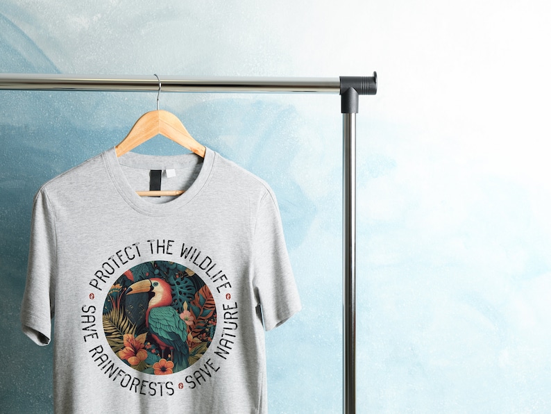 May include: Gray t-shirt with a circular graphic featuring a toucan, tropical plants, and the text "Protect the Wildlife Save Rainforests Save Nature".