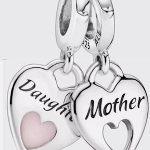 May include: Two silver heart-shaped charms. One charm says "Daughter" with a pink heart, the other says "Mother" with a heart-shaped cutout. The charms are connected by a silver loop.