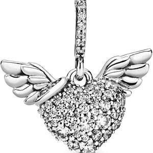 May include: A silver charm with a heart shape covered in clear cubic zirconia stones and angel wings. The charm has a loop at the top for attaching to a bracelet or necklace.