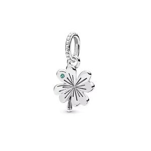 May include: A silver charm featuring a four-leaf clover design. The clover has a small green gemstone in the center of one leaf. The charm has a loop at the top, embellished with small clear stones.